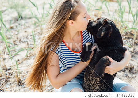 beautiful girl is playing with brown labradors beautiful girl is playing with brown labradors 34483333