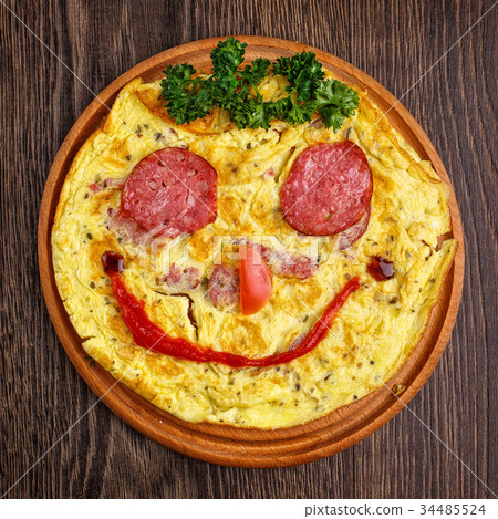 Funny omelet with sausage. Smile Funny omelet with sausage. Smile 34485524