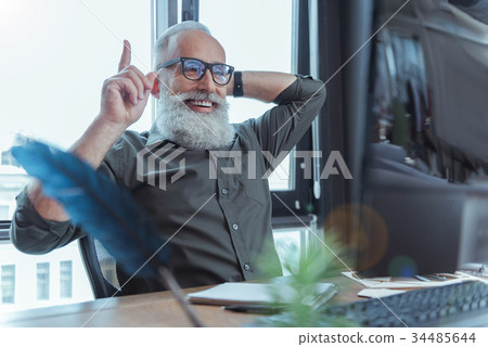 Joyful adult author working at desk Joyful adult author working at desk 34485644