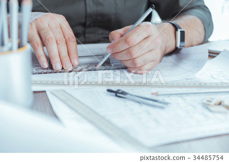Professional engineer is drawing blueprint 34485754