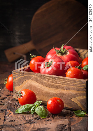 fresh tomatoes in a wooden crate fresh tomatoes in a wooden crate 34485970