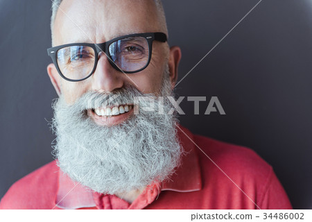 Delightful stylish gray-haired man is expressing 34486002