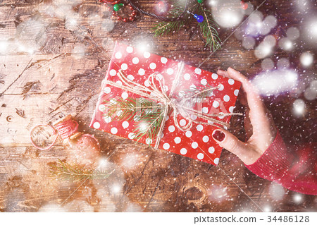 Woman's hands give christmas gift Woman's hands give christmas gift 34486128