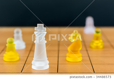 Chess glass on a wood chessboard 34486573