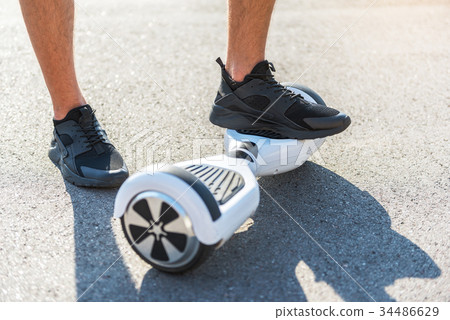 Young male feet locating on gyroscope 34486629