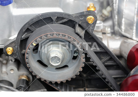 Timing belt and camshaft sprocket in car engine. Timing belt and camshaft sprocket in car engine. 34486800
