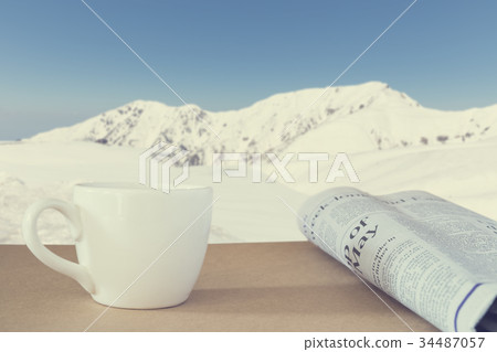 coffee and newspaper with mountain background 34487057