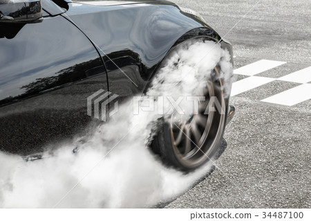 Drag racing car burns tires at start line. Drag racing car burns tires at start line. 34487100