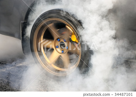 Drag racing car burns tires at start line. Drag racing car burns tires at start line. 34487101