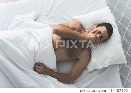 Exhausted male person wants to have a nap 34487503