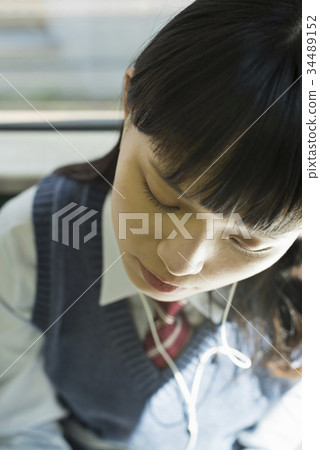 High school girl attending school train doze 34489152