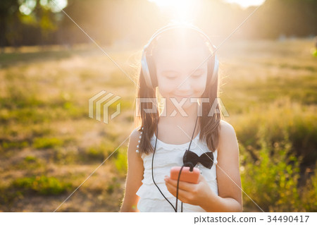 sweet girl using mobile telephone sweet girl using mobile telephone 34490417