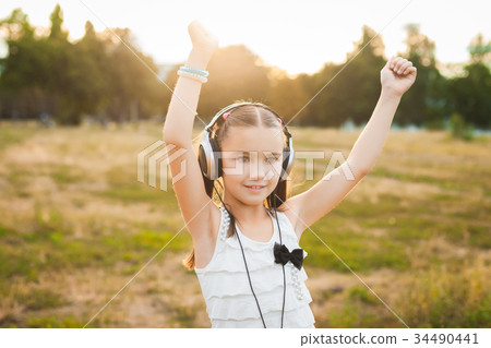 pretty girl listening music and dancing 34490441