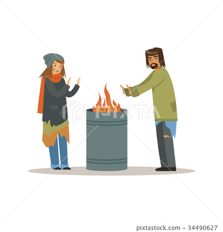 Homeless men and woman warming themselves near the Homeless men and woman warming themselves near the 34490627