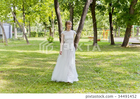 Beautiful bride in white lace dress of summer time Beautiful bride in white lace dress of summer time 34491452