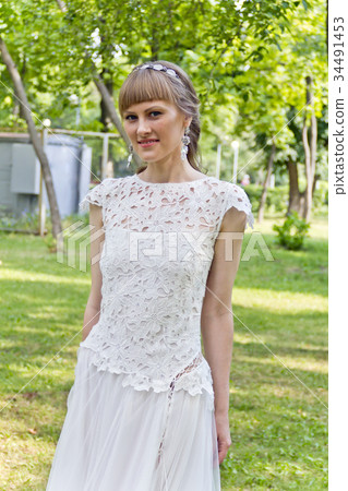 Beautiful bride in white lace dress of summer time Beautiful bride in white lace dress of summer time 34491453