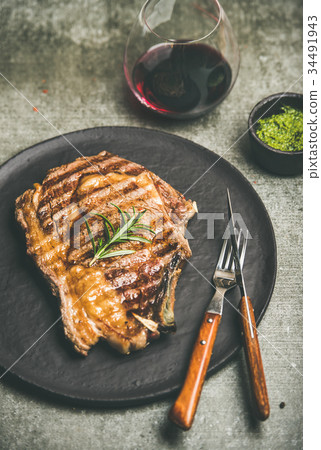 Grilled hot rib-eye beef steak with red wine 34491943