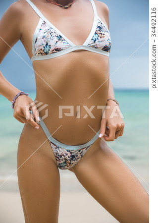 Close-up beautiful luxury slim girl in a swimsuit Close-up beautiful luxury slim girl in a swimsuit 34492116