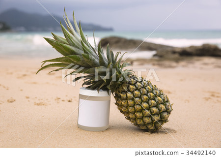 Bottle of sunblock and pineapple 34492140