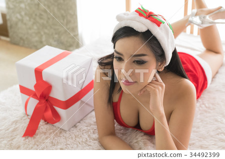 Beautiful happy woman in sexy Santa Claus clothes. 34492399