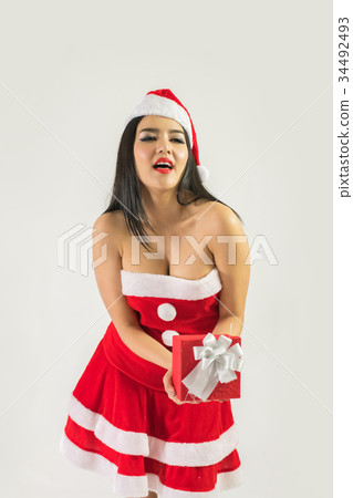 Beautiful happy woman in sexy Santa Claus clothes. Beautiful happy woman in sexy Santa Claus clothes. 34492493