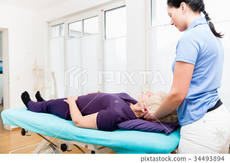 Senior woman visiting physiotherapist for massage Senior woman visiting physiotherapist for massage 34493894