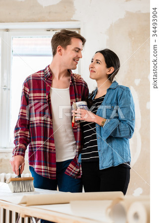 Portrait of a happy young couple holding tools for Portrait of a happy young couple holding tools for 34493904
