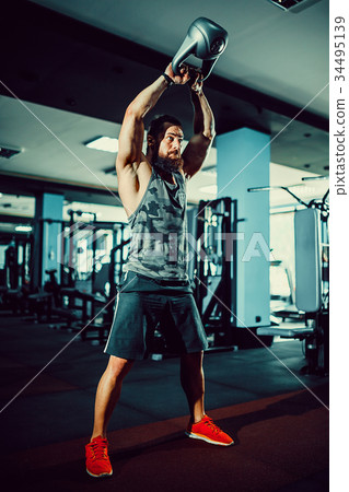 Fitness Kettlebells swing exercise man workout at 34495139