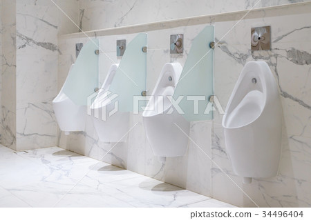 Row of urinals men public toilet in men s bathroom Stock Photo