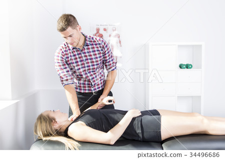 male physio therapist and woman helping patient male physio therapist and woman helping patient 34496686
