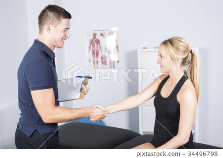 male physio therapist and woman helping patient male physio therapist and woman helping patient 34496798