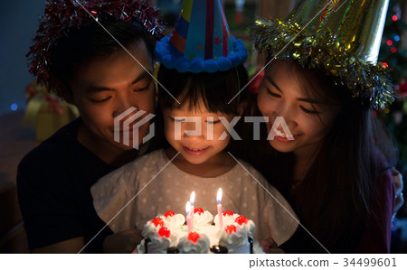Asian family a birthday party for her daughter's Asian family a birthday party for her daughter's 34499601