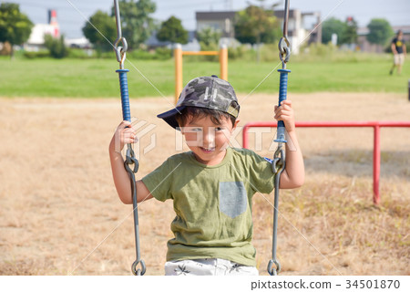A boy playing in a park 34501870
