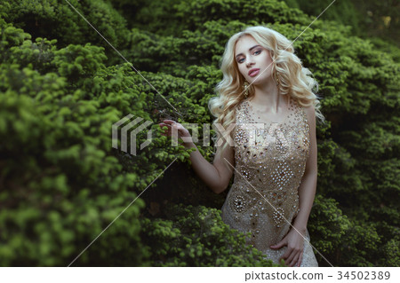 Dress decorated with stones on a woman. Dress decorated with stones on a woman. 34502389