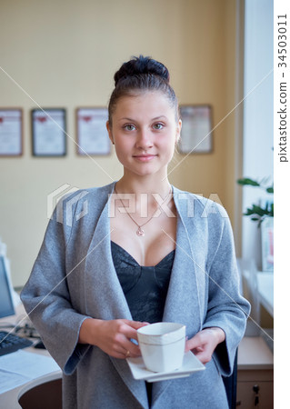 sexy provocative business woman drink coffee at 34503011