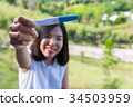short hair young woman showing the pregnancy test 34503959