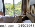 woman on the bed and watching the beautiful nature 34503963
