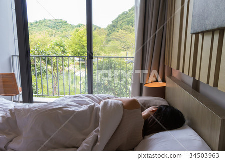 woman on the bed and watching the beautiful nature woman on the bed and watching the beautiful nature 34503963