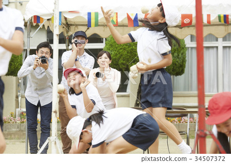 Elementary school students putting on ball at athletic meet Elementary school students putting on ball at athletic meet 34507372