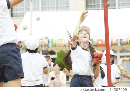 Elementary school students putting on ball at athletic meet Elementary school students putting on ball at athletic meet 34507409