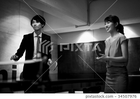 Couple playing table tennis 34507976