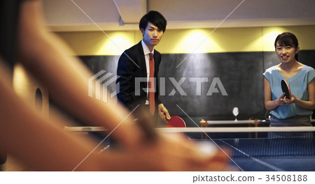 Couple playing table tennis 34508188