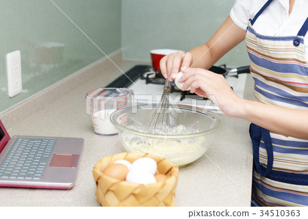 A woman enjoying cooking 34510363