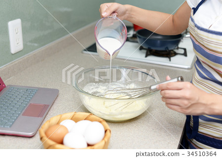 A woman enjoying cooking 34510364