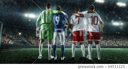 Soccer players on a rainy professional stadium 34511125