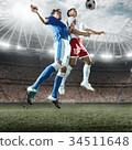 Soccer players performs an action play on a professional stadium 34511648