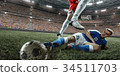 Soccer players performs an action play 34511703