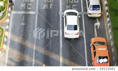 Busy city cars are passing on traffic road Busy city cars are passing on traffic road 34515081