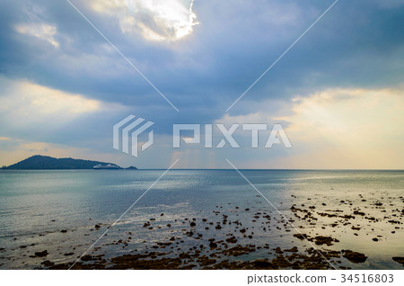 View of rocks on sandy beach in low tide 34516803