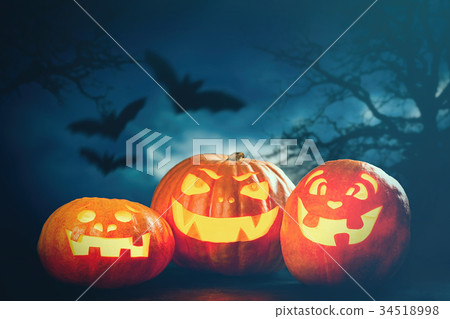 Three halloween Jack O' Lantern pumpkins 34518998